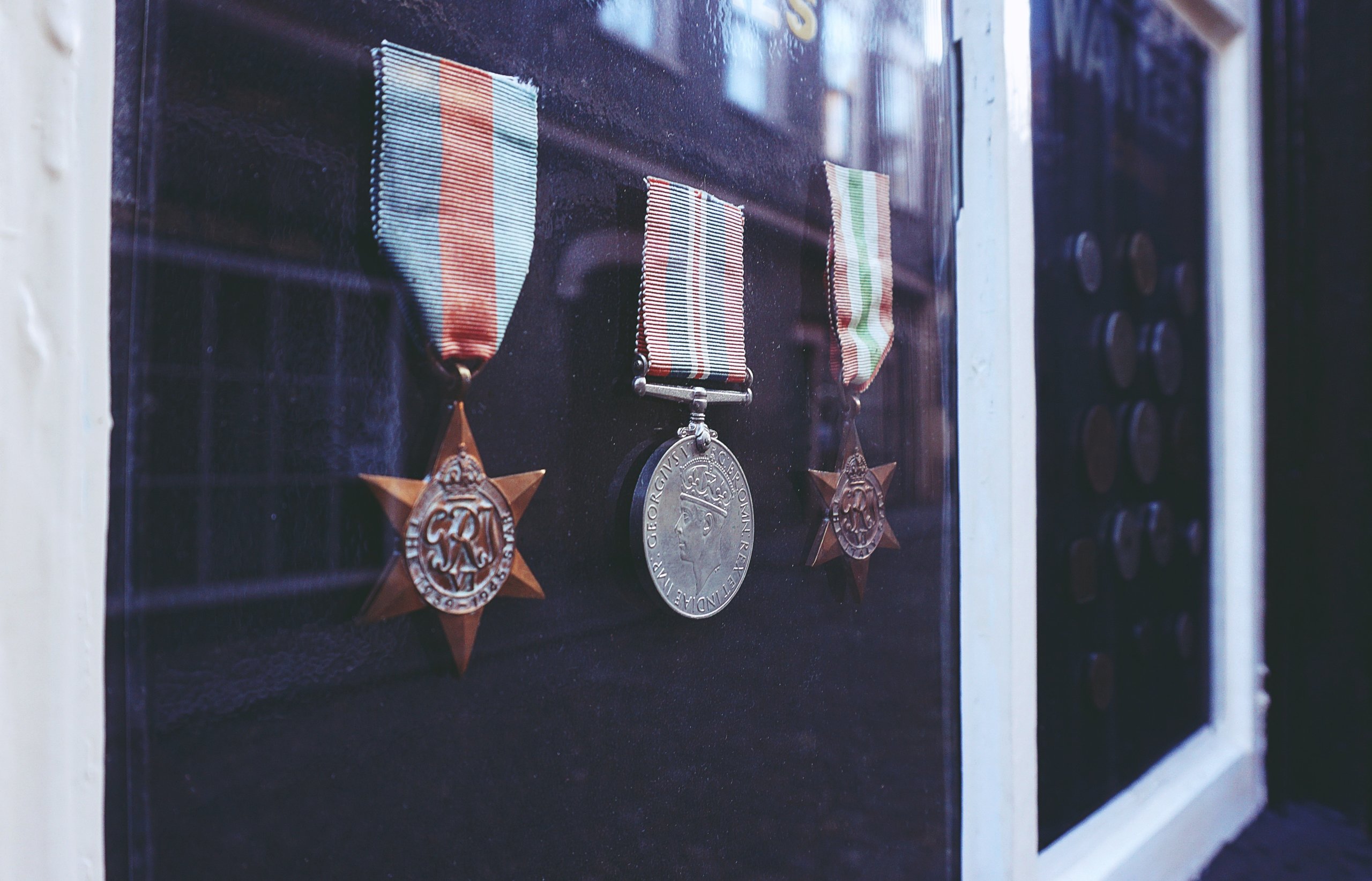 three-medals-in-glass-enclosure-2040276-scaled